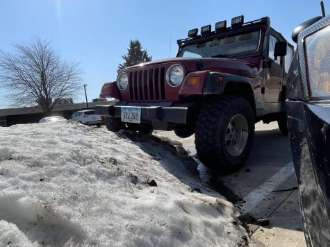Trevor Buckinghams Jeep TJ tackles snow piles in PCM parking lot. Jeep life forever!