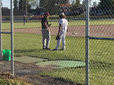 PCM senior Caleb Duinink (right) talks with head coach Jeff Lindsay (right) at baseball practice. Duinink will start at catcher for his final season after starting throughout his high school career. Lindsay is always getting him to improve. The 2021 season will start on Monday, May 24, against Pella at Pella High School. 

