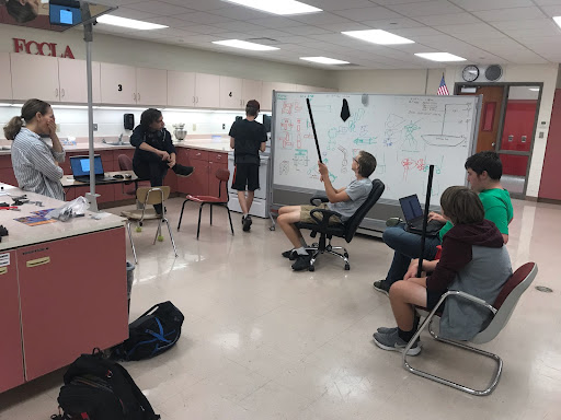 PCM Robotics junior Evan Johnson leads a discussion about goals for the year as well as finances that the club has. The whiteboard is used for putting ideas on before they are either erased or taken a picture of, which is how they are remembered. From left to right: advisor Jennifer Brown, junior Justin Hall, sophomore Joel Brown, junior Evan Johnson, sophomore Ross Tuttle and freshman David Westphal.