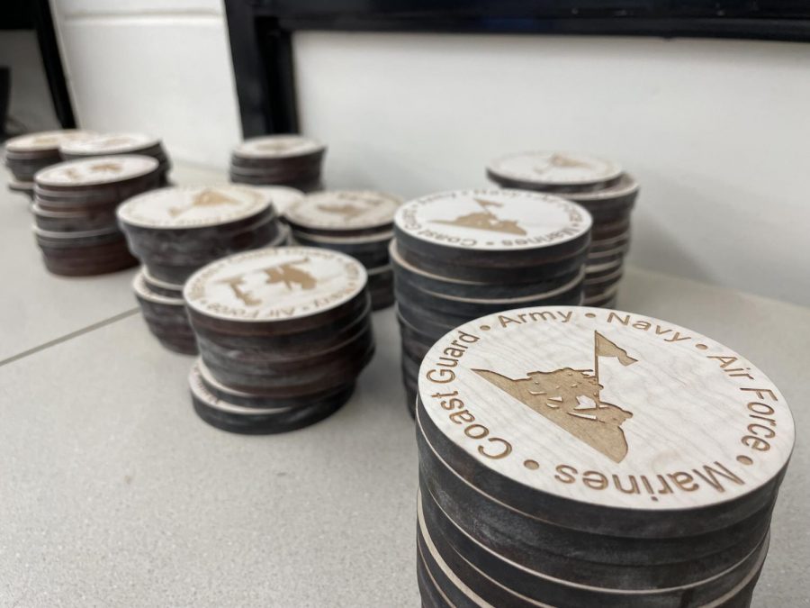 Coasters sit in piles after being engraved by the laser. 