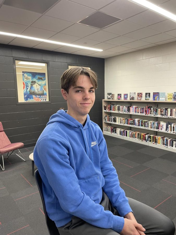 Caden Bouwkamp hangs out in the library in his blue hoodie!