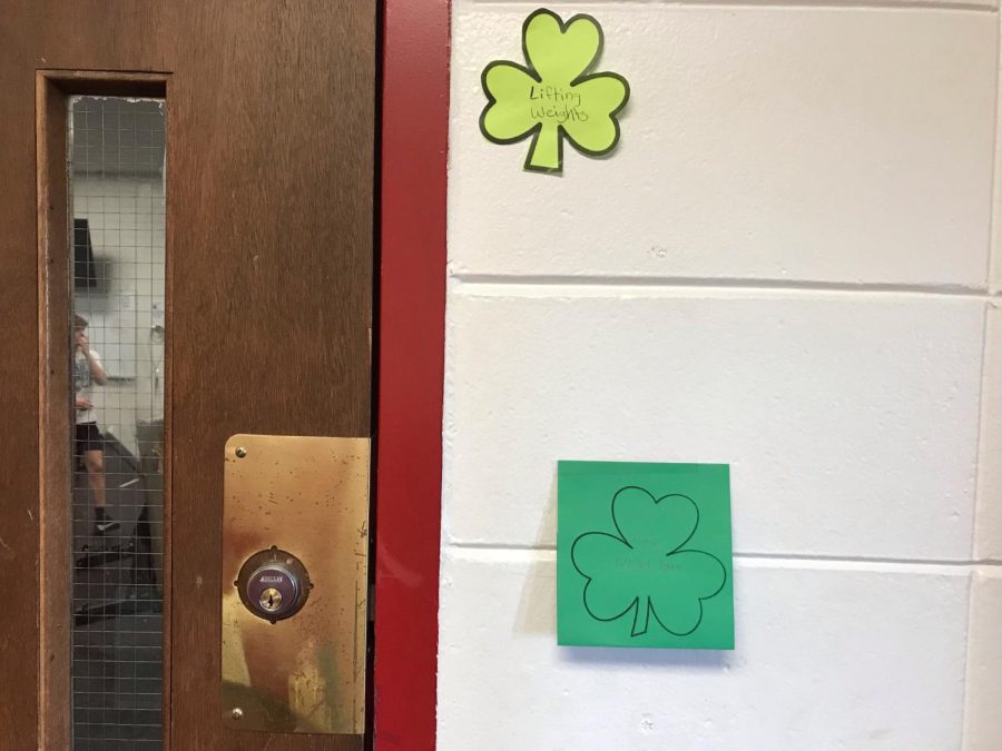 The two shamrocks on the door to the weight room made by students. The shamrocks really stand out because paper decorations in a weight room is an obscurity.  