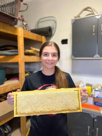 Reed poses with one of her many honeycomb harvests from this year. Despite losing bees, the quality of honey has remained excellent. 