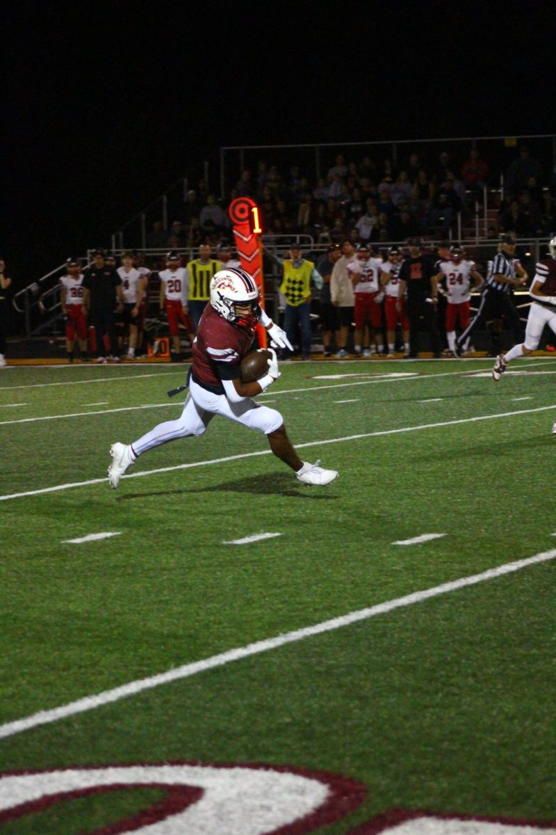 Senior Adrien Robbins running the ball at the homecoming game