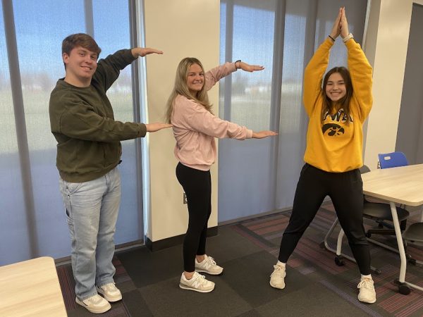 FFA members Carter Dudley, Gretchen Uitermarkt, and Seriah Nolin pose to spell out, "FFA."